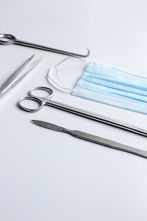 instruments for plastic surgery on white background