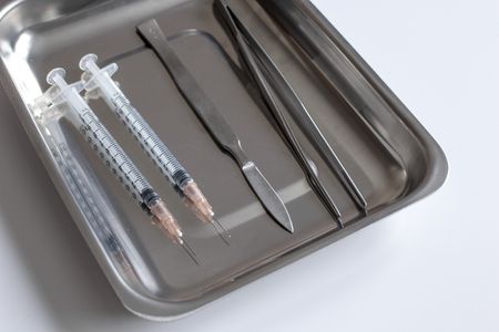 instruments for plastic surgery on white background