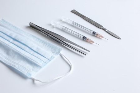 instruments for plastic surgery on white background