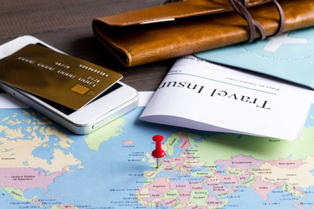 concept booking travel insurance on wooden backgroundの写真素材