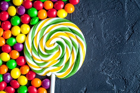 sweets and sugar candies on dark background top view.の写真素材