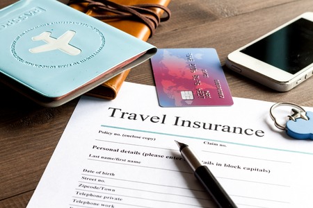 concept booking travel insurance on wooden backgroundの写真素材