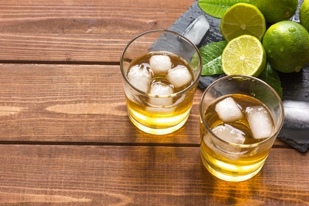 glass of whiskey on wooden background close upの写真素材