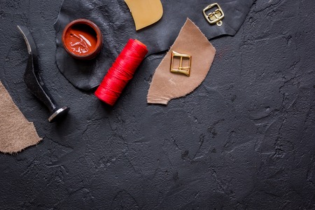 leather craft instruments on dark background top view mock up.の写真素材