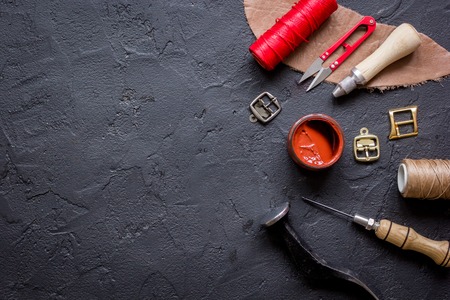 leather craft instruments on dark background top view mock up.