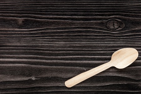 wooden kitchen utensils on dark wooden background top view mock upの写真素材
