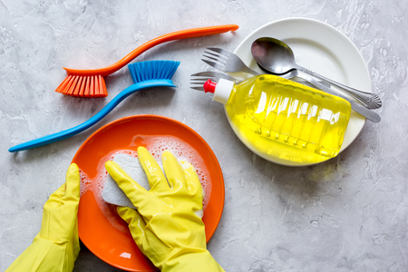 concept of woman washing dishes on gray background top viewの写真素材