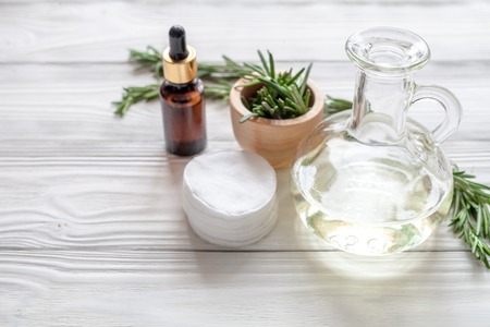 organic cosmetics with extracts of herbs - rosemary on wooden backgroundの写真素材