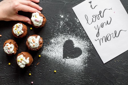 concept of Valentine's Day cupcakes on dark background top view.の写真素材