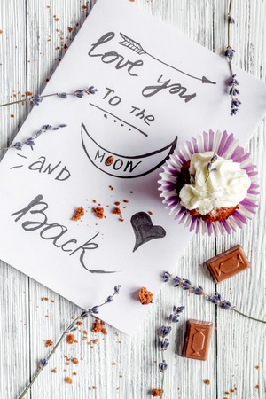 concept of Valentine's Day cupcakes on wooden background top view.の写真素材