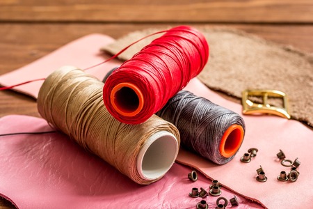 leather craft instruments on wooden background close up.の写真素材