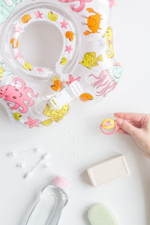 baby accessories for bath with duck on white background top view
