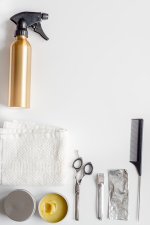 hairdresser working desk preparation for cutting hair top view on white backgroundの写真素材