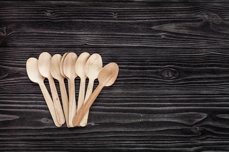 wooden kitchen utensils on dark wooden background top view mock upの写真素材