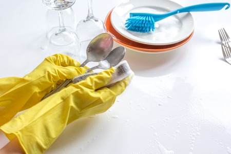 concept of woman washing dishes on white backgroundの写真素材