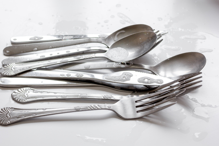 concept of washing dishes on white background close up
