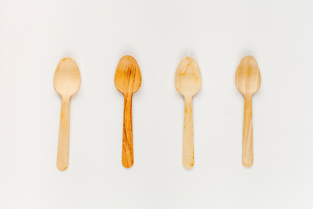 wooden kitchen utensils on white background top view patternの写真素材