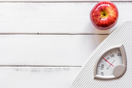floor scale and apple on wooden background top viewの写真素材