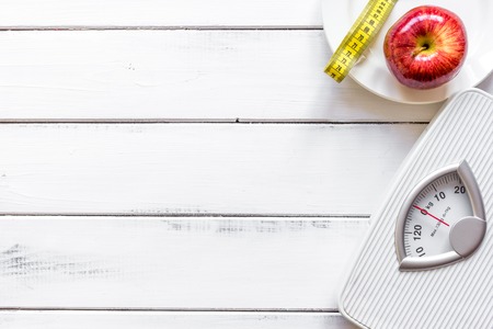 floor scale and apple on wooden background top viewの写真素材