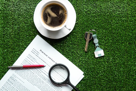 concept of buying house on green background top viewの写真素材