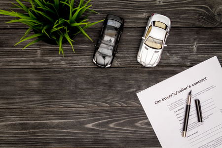 concept of buying car on dark wooden background top viewの写真素材