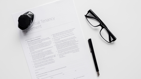 signing of agreement top view on white backgroundの写真素材