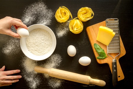 chef cooking pasta top view on dark backgroundの写真素材