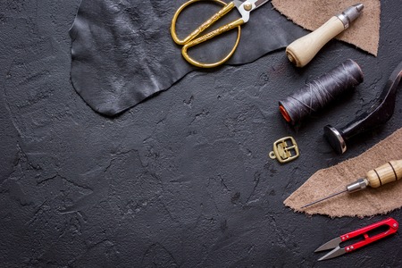 leather craft instruments on dark background top view mock up