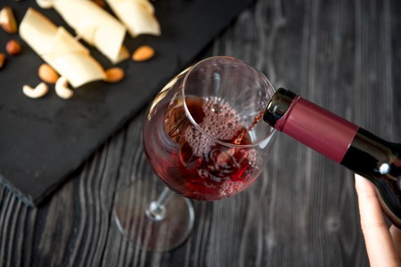 red wine with cheese on wooden background top view.の写真素材