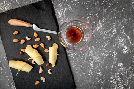 red wine with cheese on dark background top view.の写真素材