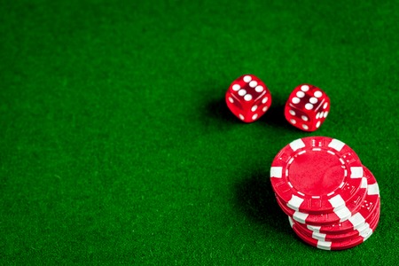 poker chips and dice on green background top viewの写真素材