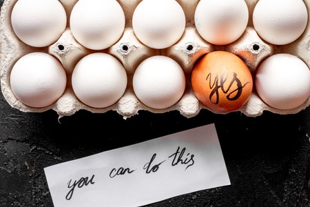 concept of correct choice eggs on dark background top viewの写真素材