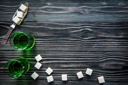 absinthe in glass on wooden background top view mock up