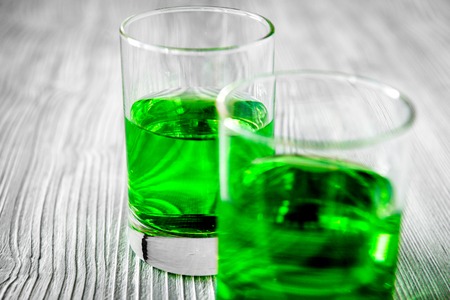 absinthe with sugar cubes and spoon on wooden backgroundの写真素材