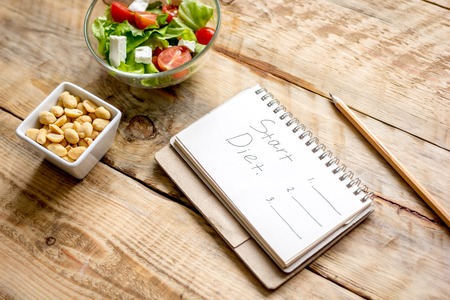 concept diet and slimming plan with vegetables close up on wooden backgroundの写真素材