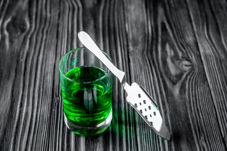 absinthe with sugar cubes and spoon on wooden background close up.の写真素材