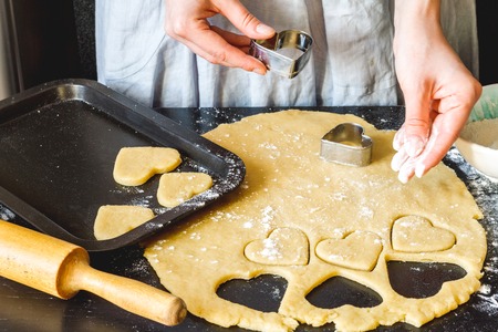 cooking homemade cookies with hands on dark backgroundの写真素材