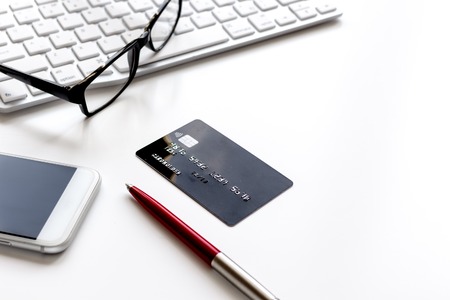 credit card, keyboard, smartphone and coffee cup on white backgroundの写真素材