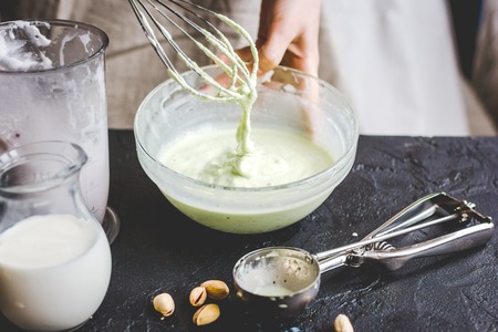 organic ice cream homemade process on dark background with handsの写真素材