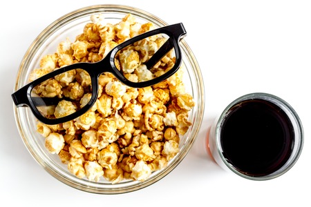 concept of watching movies with popcorn top view on white backgroundの写真素材