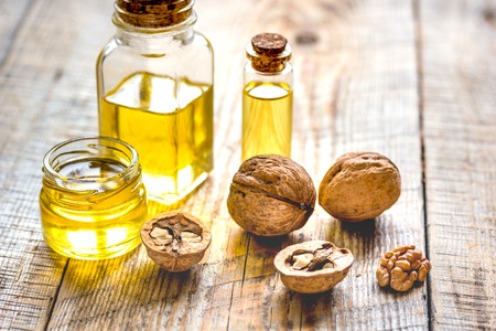 cosmetic and therapeutic walnut oil on wooden background.の写真素材
