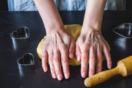 cooking homemade cookies with hands on dark background.の写真素材
