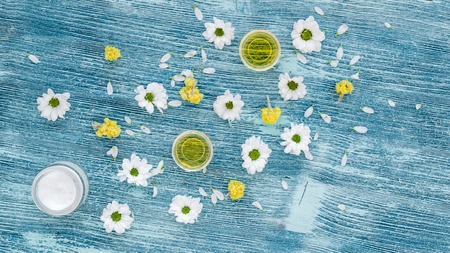 organic cosmetics with camomile on blue background top view.の写真素材