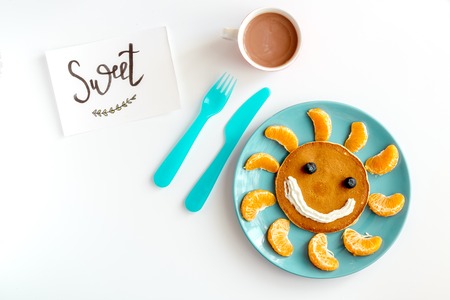 concept kid breakfast with pancake top view on white backgroundの写真素材