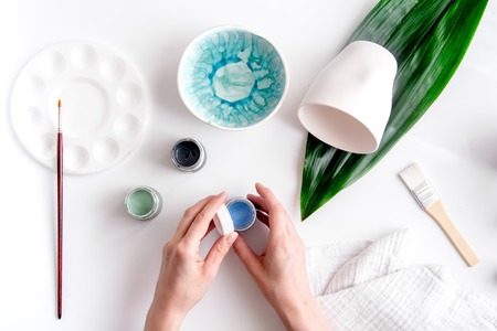 painted ceramic cup on white background top viewの写真素材