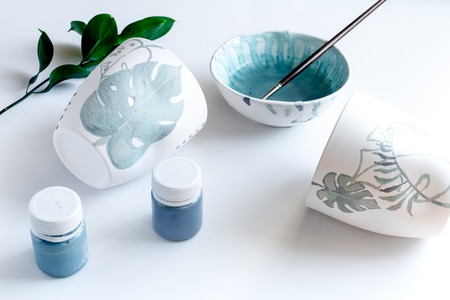 painted ceramic cup on white backgroundの写真素材