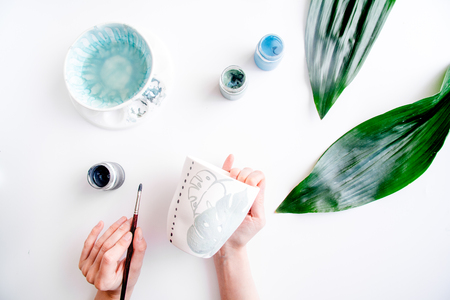 painted ceramic cup on white background top viewの写真素材