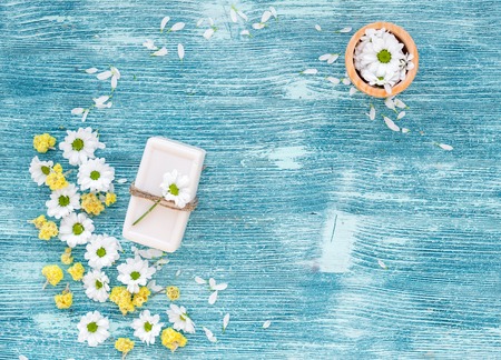 Organic beauty care with chamomile on blue layout top view.の写真素材