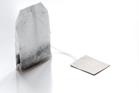 Close up black tea in teabag on white table background mock-upの写真素材