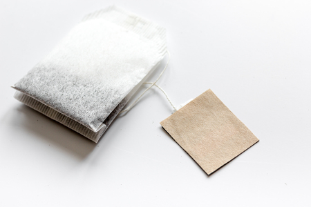 Close up black tea in teabag on white table background mock-upの写真素材